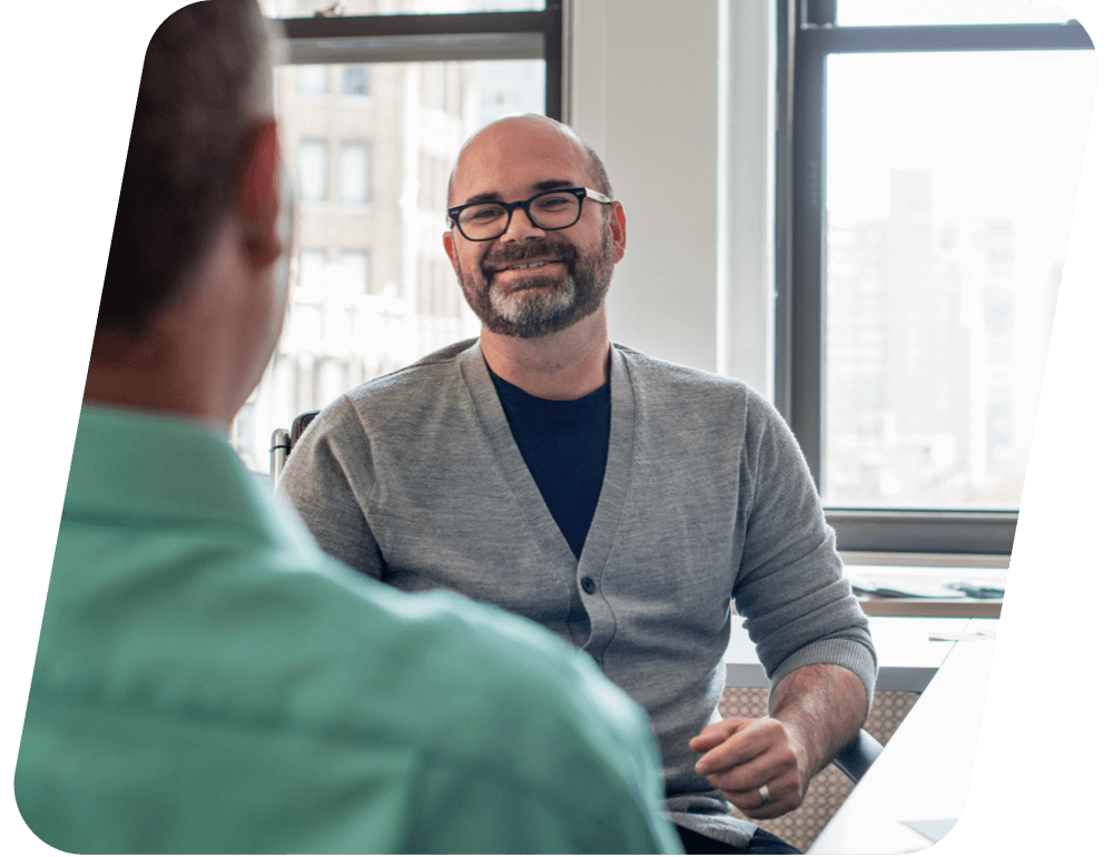 A man talking and smiling.