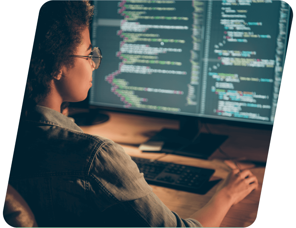 Woman working on code at a computer.